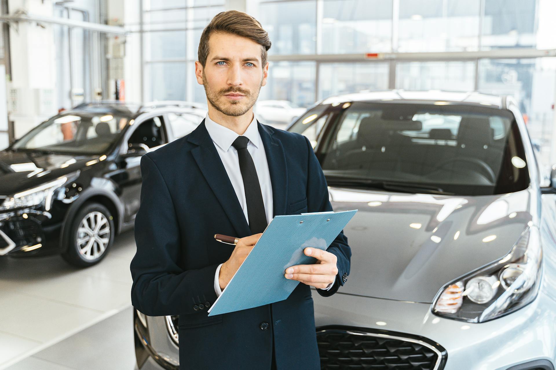Man-in-Blue-Business-Attire-Holding-Blue-Folder
